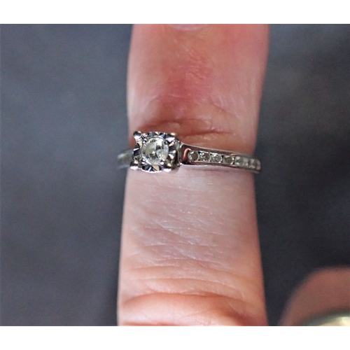 321 - 9ct WHITE GOLD AND DIAMOND RING Diamond carat weight is 1/4ct.