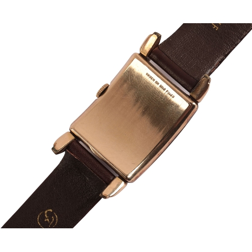 335 - GRUEN CURVEX: A GENTLEMAN'S GOLD-PLATED WRISTWATCH with a manual wind movement, the rectangular whit... 