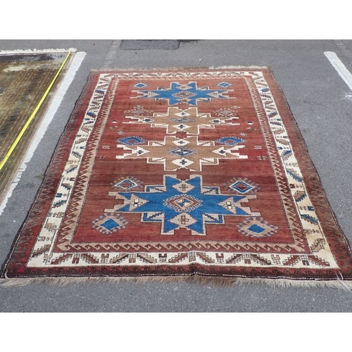 533 - A TRIBAL PATTERNED RUG in browns and blue 160 x 230cm plus fringes