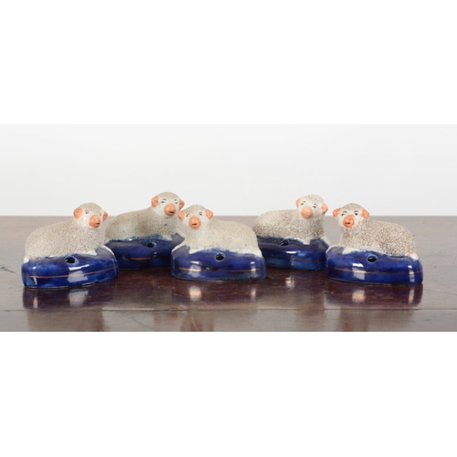 102 - TWO PAIRS OF STAFFORDSHIRE PEN HOLDERS modelled as sheep, each 8.5cm high x 6.5cm high, plus a singl... 