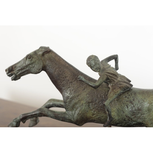 116 - AFTER THE ANTIQUE, A BRONZE FIGURE OF THE JOCKEY OF ARTEMISION raised on a marble plinth base, 35cm ... 