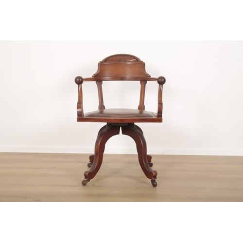 117 - AN EDWARDIAN MAHOGANY DESK CHAIR with sunburst carved cresting and stuffed leather serpentine seat o... 