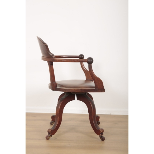 117 - AN EDWARDIAN MAHOGANY DESK CHAIR with sunburst carved cresting and stuffed leather serpentine seat o... 