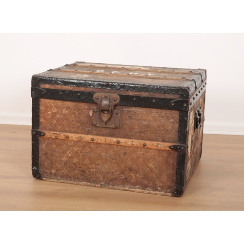 17 - A VINTAGE TRAVEL TRUNK decorated in Louis Vuitton style, the hinged lid opening to an interior fitte... 