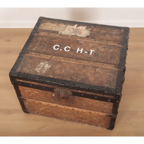 17 - A VINTAGE TRAVEL TRUNK decorated in Louis Vuitton style, the hinged lid opening to an interior fitte... 