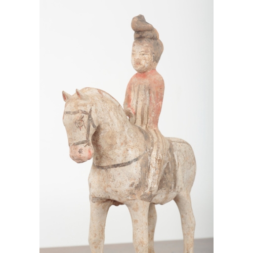 18 - A CHINESE PAINTED POTTERY HORSE AND RIDER of Tang style, 35cm high