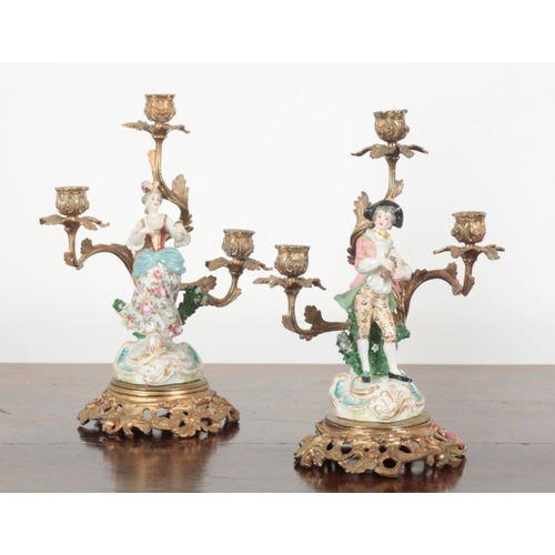 21 - A PAIR OF 19TH CENTURY FRENCH ORMOLU THREE BRANCH CANDELABRA the porcelain figures probably by Samso... 