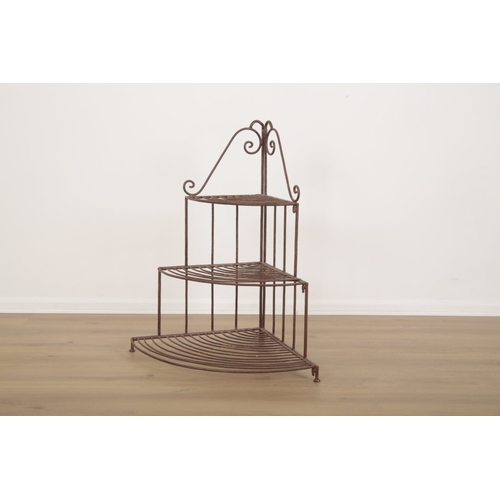 24 - A WROUGHT IRON THREE TIER JARDINIERE STAND with scrollwork gallery over graduated shelves, 83cm high... 