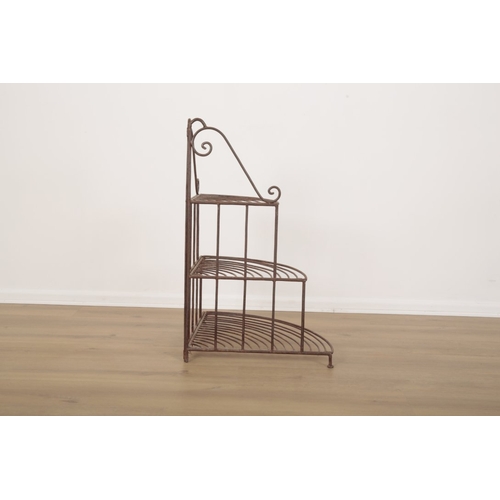24 - A WROUGHT IRON THREE TIER JARDINIERE STAND with scrollwork gallery over graduated shelves, 83cm high... 