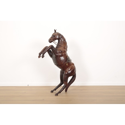 26 - A LEATHER MODEL OF A REARING HORSE complete with saddle and reigns, 97cm high