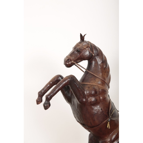 26 - A LEATHER MODEL OF A REARING HORSE complete with saddle and reigns, 97cm high