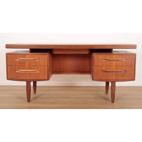 27 - A FRESCO FLOATING TOP TEAK DESK BY G-PLAN with a central velvet lined drawer and two further short d... 