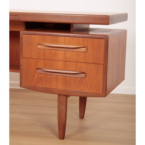27 - A FRESCO FLOATING TOP TEAK DESK BY G-PLAN with a central velvet lined drawer and two further short d... 