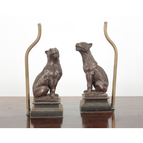 38 - A PAIR OF PATINATED METAL TABLE LAMP BASES 20th century, each figured as seated hounds, on moulded p... 
