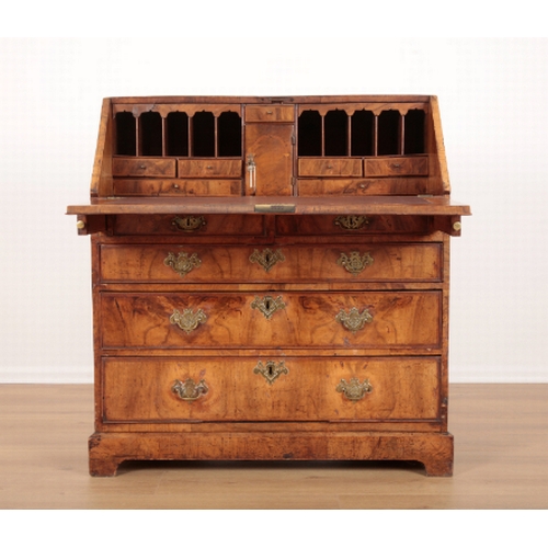 389 - AN EARLY GEORGE III FIGURED WALNUT BUREAU the crossbanded slope enclosing fitted interior, two short... 