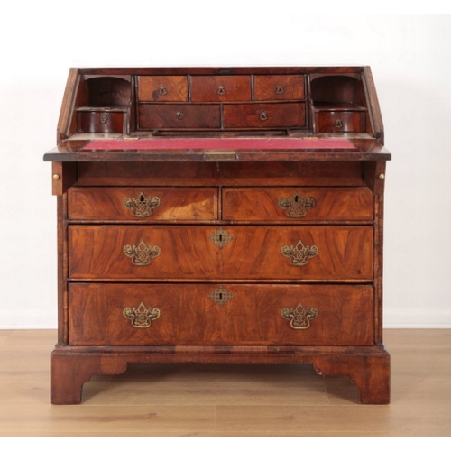 39 - A GEORGE I WALNUT BUREAU the fall front opening to an inset red baize writing surface and an interio... 