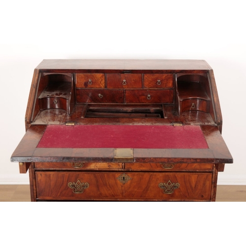 39 - A GEORGE I WALNUT BUREAU the fall front opening to an inset red baize writing surface and an interio... 