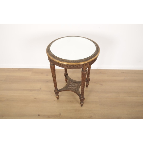 394 - A CARVED AND GILTWOOD OCCASIONAL TABLE the circular top with mirror glazed surface, on four turned l... 