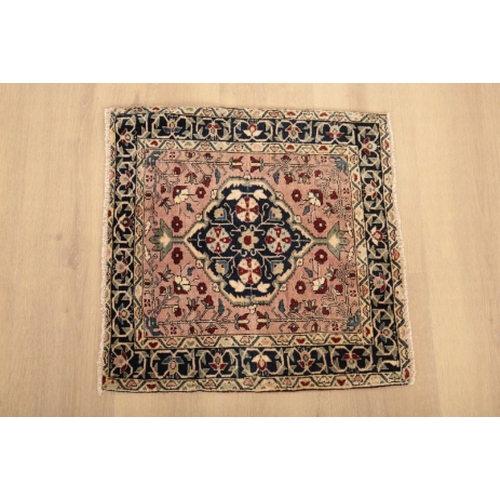 41 - A WAGIREH SMALL RUG with a central floral medallion, 55cm square