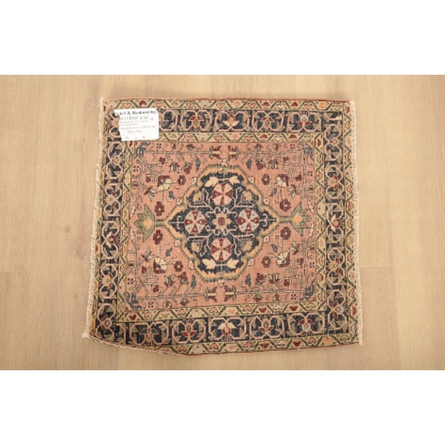 41 - A WAGIREH SMALL RUG with a central floral medallion, 55cm square