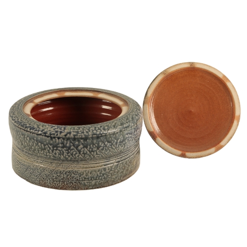 42 - *JANE HAMLYN (B. 1940): A LARGE SALT GLAZED STONEWARE LIDDED VESSEL the body of slightly waisted for... 