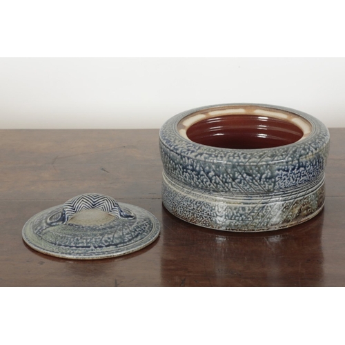 42 - *JANE HAMLYN (B. 1940): A LARGE SALT GLAZED STONEWARE LIDDED VESSEL the body of slightly waisted for... 