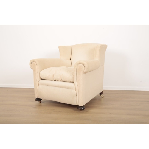 52 - A VICTORIAN WINGBACK ARMCHAIR with pale cotton covers, on turned front legs and block rear legs inse... 
