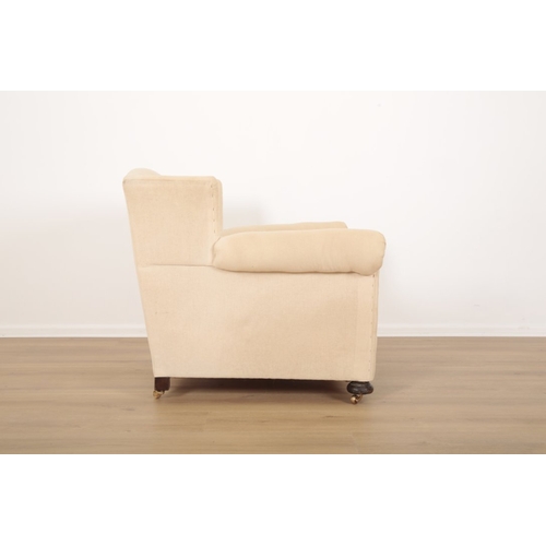 52 - A VICTORIAN WINGBACK ARMCHAIR with pale cotton covers, on turned front legs and block rear legs inse... 