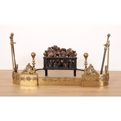 53 - A REGENCY STYLE BRASS FIRE GUARD mounted with griffons and decorated with foliate banding, two uprig... 
