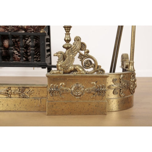 53 - A REGENCY STYLE BRASS FIRE GUARD mounted with griffons and decorated with foliate banding, two uprig... 