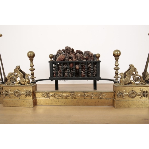 53 - A REGENCY STYLE BRASS FIRE GUARD mounted with griffons and decorated with foliate banding, two uprig... 