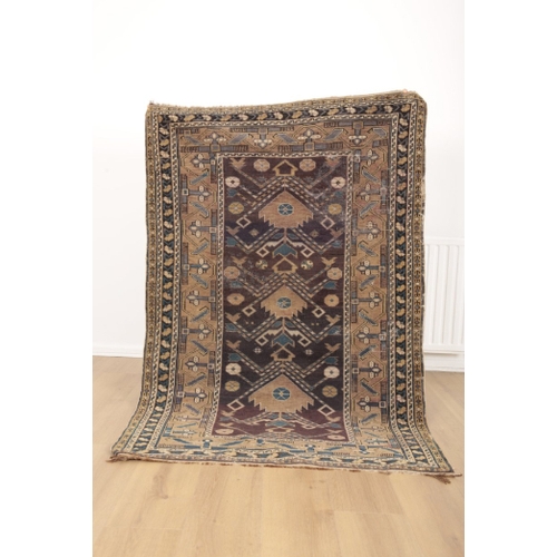 55 - A NORTH PERSIAN RUG 20th century, the dark blue ground woven with repeating geometric motifs, 175cm ... 