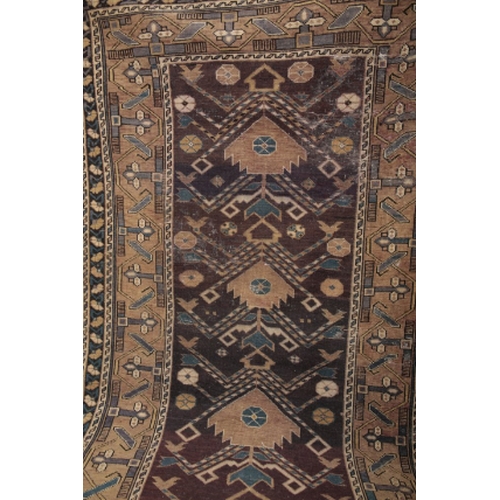 55 - A NORTH PERSIAN RUG 20th century, the dark blue ground woven with repeating geometric motifs, 175cm ... 