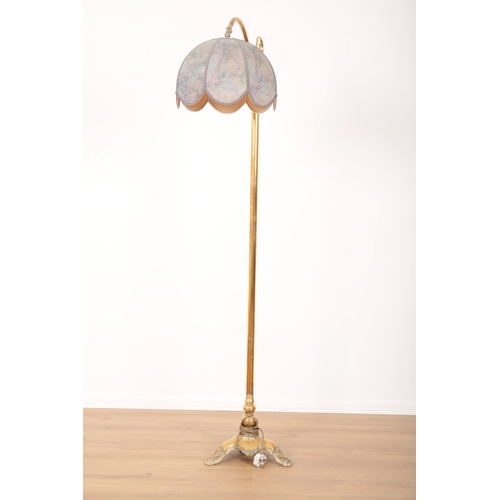56 - A PAIR OF BRASS STANDARD LAMPS 19th century, the electric fitments and fabric shades held on scrolle... 