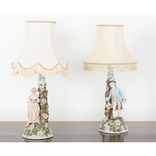 59 - A PAIR OF THURINGIAN PORCELAIN TABLE LAMPS 19th century, modelled with a gentleman and a lady in 18t... 