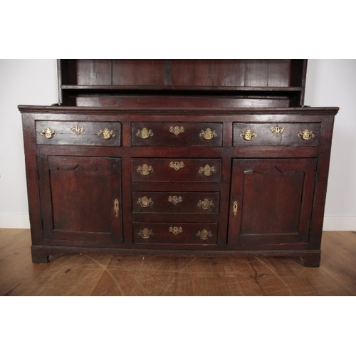 64 - AN 18TH CENTURY OAK DRESSER the upper section with moulded cornice over three shelves, the base fitt... 