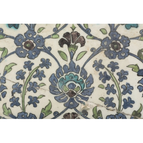 89 - AN IZNIK POTTERY TILE probably 19th century, decorated in cobalt blue and turquoise with flower head... 