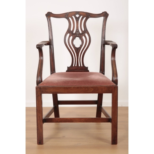 93 - A GEORGE III MAHOGANY ARMCHAIR the shaped cresting rail over a pierced vase shaped back splat, a dro... 