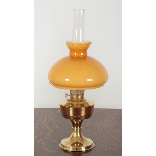 151 - A PAIR OF 20TH CENTURY ALADDIN BRASS TABLE OIL LAMPS with orange and white cased glass shades , each... 