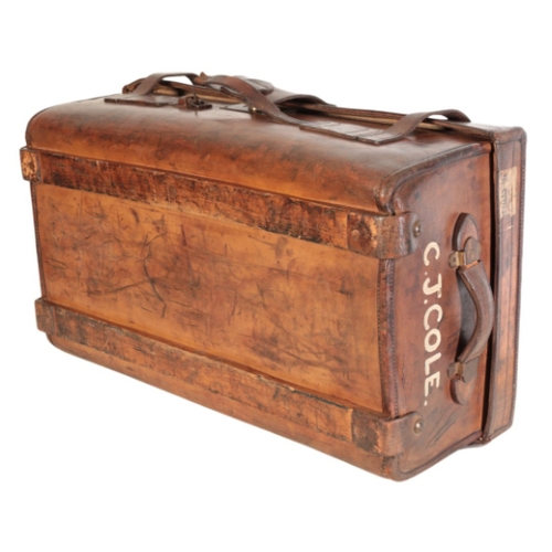 256 - A VICTORIAN BROWN LEATHER TRAVELLING TRUNK with leather carrying handles, leather straps and various... 