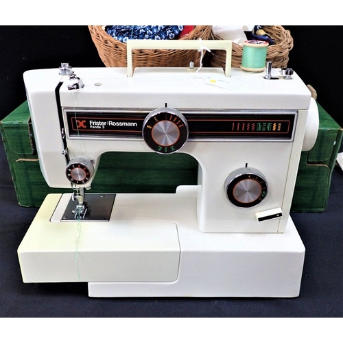 121 - A FRISTER ROSSMAN PANDA 3 SEWING MACHINE with a quanity of sewing accessories