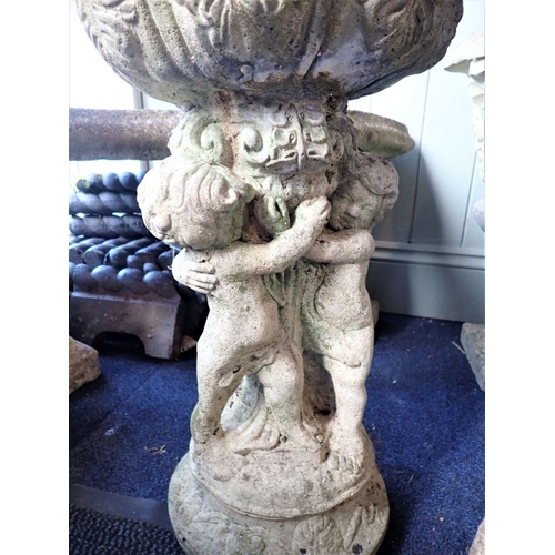 15 - A RECONSTITUTED STONE BIRDBATH with a cherub urn, a planter, a pigeon, and a dog