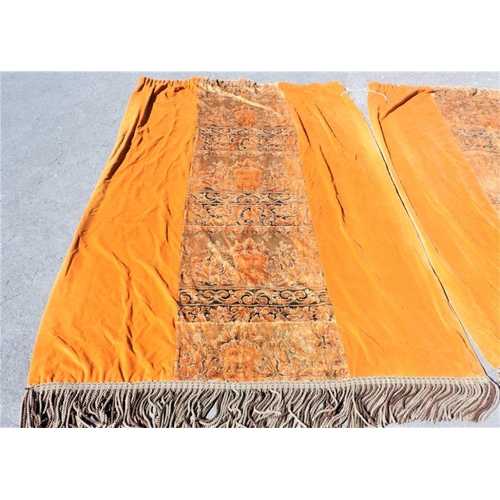 196 - A PAIR OF BURNT ORANGE VELVET CURTAINS, WITH CENTRAL FIGURED PANELS with metallic thread work, and b... 