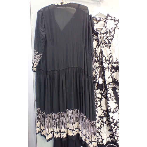 221 - A BLACK AND WHITE EMBROIDERED GOWN with a beaded chiffon gathered jacket over a black crepe dress