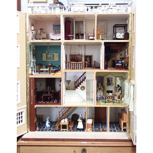 228 - A LARGE FULLY FURNISHED FOUR-STOREY DOLLS HOUSE in the style of a 19th century town house, three flo... 