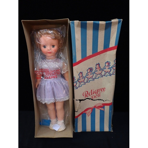 235 - AN ARMAND MARSEILLES COMPOSITION HEADED DOLL (a/f) and a vintage 'Pedigree' doll (2)