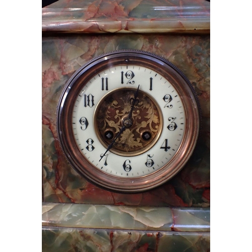 300 - A FIGURED ONYX MANTEL CLOCK of architectural form, with French movement striking on a gong 33cm wide