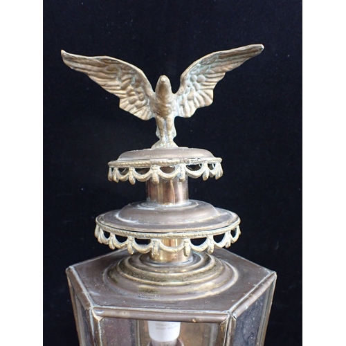 309 - TWO PAIRS OF WALL-MOUNTED BRASS LANTERNS one with eagle surmount, electrified, 68cm and 53cm high