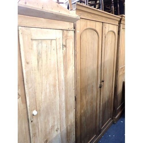 917 - HEAL & SON: A VICTORIAN STRIPPED PINE WARDROBE with arched panel doors and fitted interior 126cm wid... 