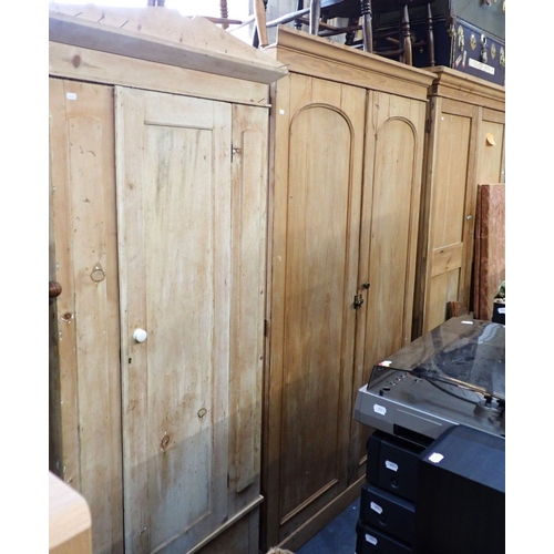 917 - HEAL & SON: A VICTORIAN STRIPPED PINE WARDROBE with arched panel doors and fitted interior 126cm wid... 